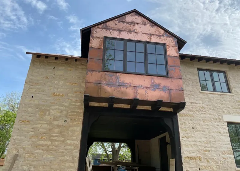Copper metal panel facade on a stone building for Skylight Installation in Tenafly