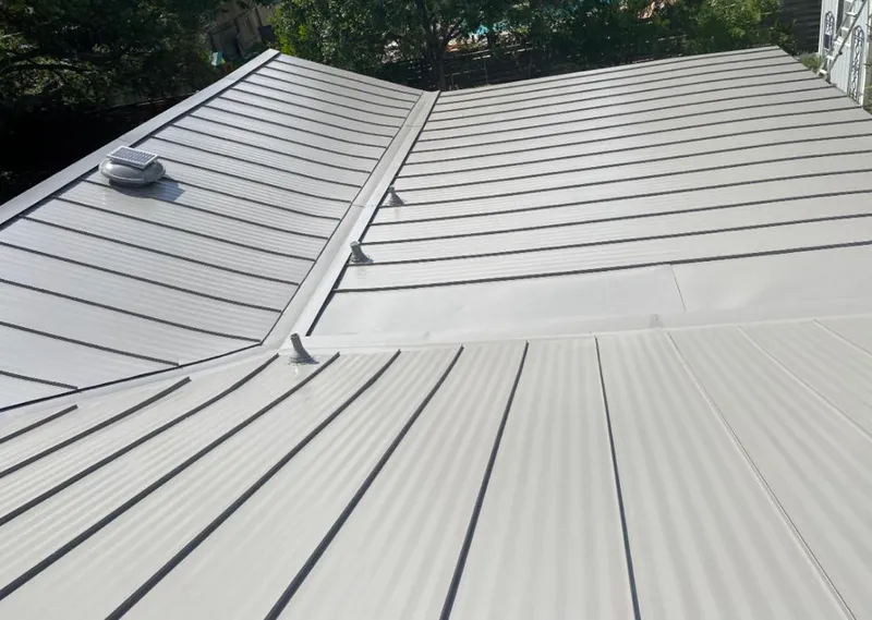 Solar attic fan installed on a metal roof for Roof Ventilation in Tenafly